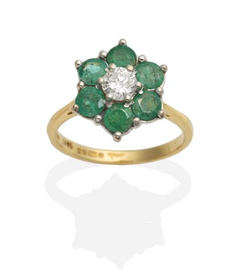 Lot 409 - An 18 Carat Gold Diamond and Emerald Cluster Ring, a round brilliant cut diamond within a...