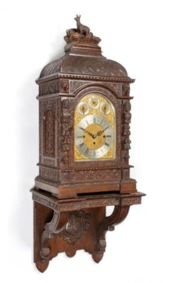 Lot 436 - A Carved Oak Chiming Bracket Clock with the Original Wall Bracket, circa 1890, case carved with...
