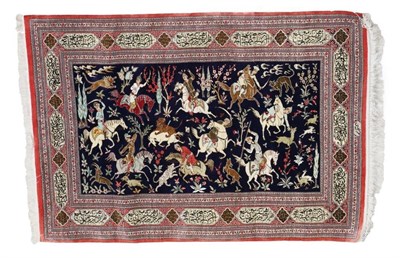 Lot 449 - Ghom Silk Rug Central Iran, late 20th century The indigo field depicting hunting scenes enclosed by