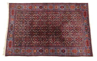 Lot 452 - Sultanabad Carpet West Iran, circa 1900 The deep indigo Herati field enclosed by sky blue...
