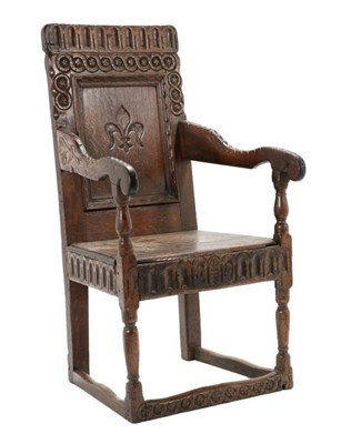 Lot 478 - A 17th Century Joined Oak Wainscot Armchair, the nulled top rail and guilloche carved back...