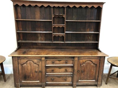 Lot 479 - A Mid 18th Century Enclosed Oak Dresser Base, with a central bank of three drawers flanked by...