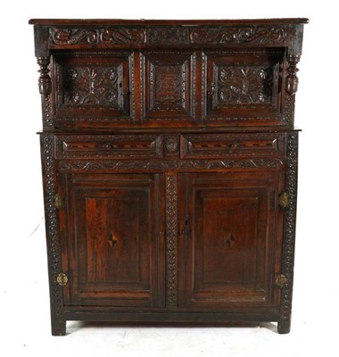 Lot 483 - A Joined Oak Press Cupboard, the later boarded top above a carved frieze bearing initials TCM...