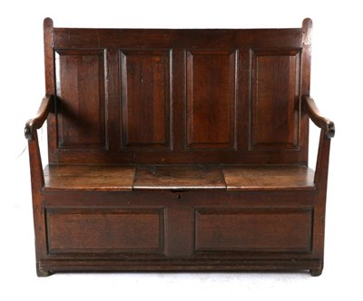 Lot 492 - A George III Oak Panel-Back Settle, late 18th century, with four fielded panels above downswept...
