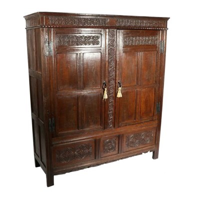 Lot 495 - A Late 17th/Early 18th Century Carved Oak Press Cupboard, the fielded panel doors enclosing...