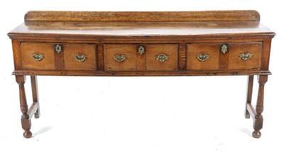Lot 500 - An Early 18th Century Oak Low Dresser, with three frieze drawers above a moulded base, on...