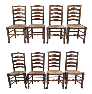 Lot 505 - A Set of Eight Late George III Ash and Rush-Seated Ladder-Back Chairs, early 19th century, with...