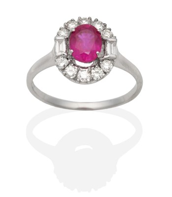 Lot 451 - An 18 Carat White Gold Pink Sapphire and Diamond Cluster Ring, an oval cut pink sapphire in a...