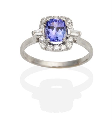 Lot 464 - An 18 Carat White Gold Tanzanite and Diamond Cluster Ring, a cushion cut tanzanite in a claw...