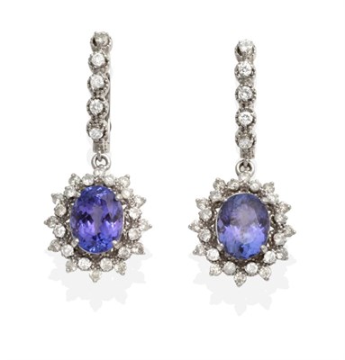 Lot 467 - A Pair of Tanzanite and Diamond Drop Earrings, a line of articulated round brilliant cut...