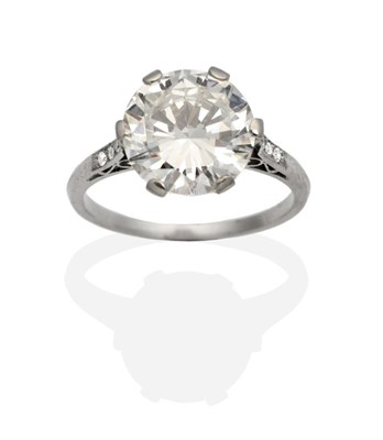 Lot 471 - A Solitaire Diamond Ring, a round brilliant cut diamond in a six claw setting, to diamond set...