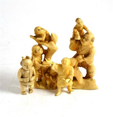 Lot 32 - Three small Japanese ivory carvings and a small Chinese ivory of a boy, all 19th century (4)