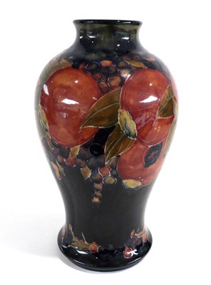 Lot 574 - William Moorcroft (British, 1872-1945): A Pomegranate Pattern Baluster Vase, on a blue ground,...