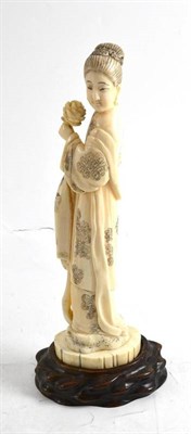 Lot 111 - A Japanese carved walrus tusk figure of a lady circa 1900, on wood stand