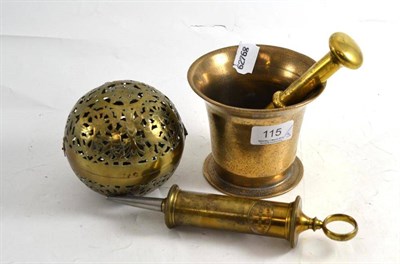 Lot 115 - A late 19th/early 20th century Indian pierced brass gimbal hand warmer, a brass syphilis...