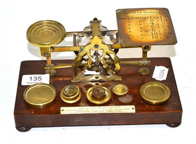 Lot 135 - A set of brass postal scale with weights