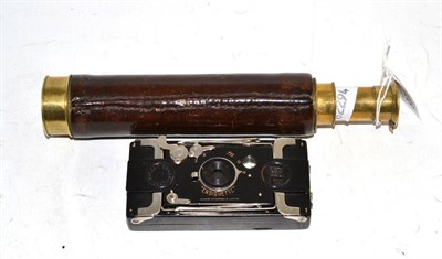 Lot 138 - A brass and leather two draw telescope and an Ensignette pocket camera in leather case