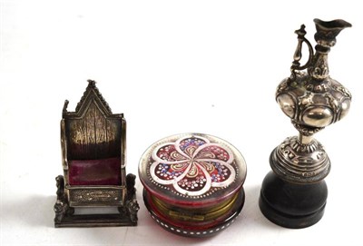 Lot 200 - A small cranberry glass box, miniature silver ewer and a miniature silver alter chair pin cushion