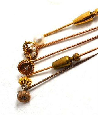 Lot 216 - Five diamond set and pearl stick pins, one stamped '375'