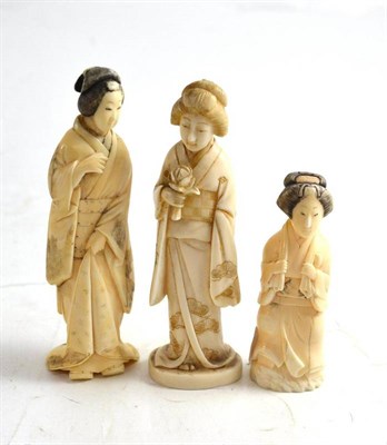 Lot 237 - A Japanese carved elephant ivory maiden circa 1910 and two other walrus examples similar (3)