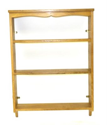 Lot 750 - Lizardman: A Derek Slater English Oak Hanging Open Plate Rack, shaped top rail, two shelves...