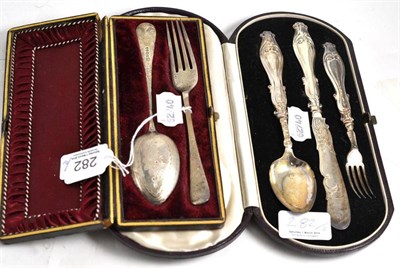 Lot 282 - A Victorian silver three piece Christening set with scroll handles, Birmingham 1859 and another...