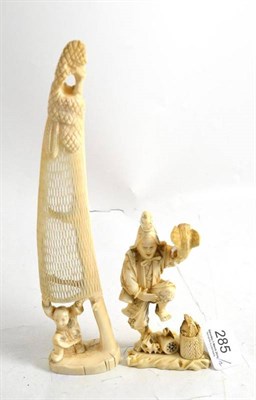 Lot 285 - A Japanese carved walrus ivory dancing hawk trainer, circa 1910 and a one piece carved walrus ivory