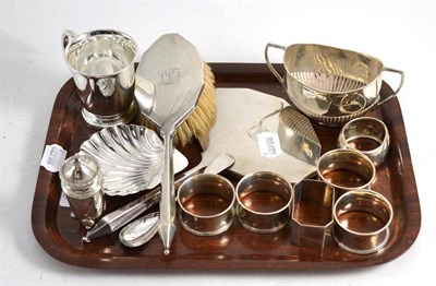 Lot 290 - Six silver napkin rings, silver pepperette, silver mounted brush and mirror, shell dish, mug, a...