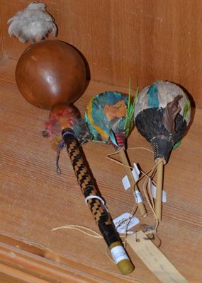 Lot 299 - Three Indian feather trimmed gourd rattles