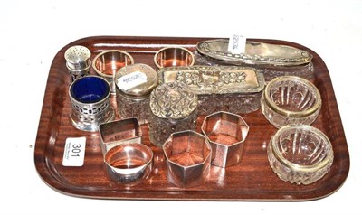 Lot 301 - A collection of silver including six napkin rings, silver topped jars, salts etc