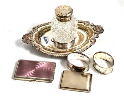 Lot 303 - Silver inkstand with cut glass bottle, two silver napkin rings, silver stamp case and a silver...