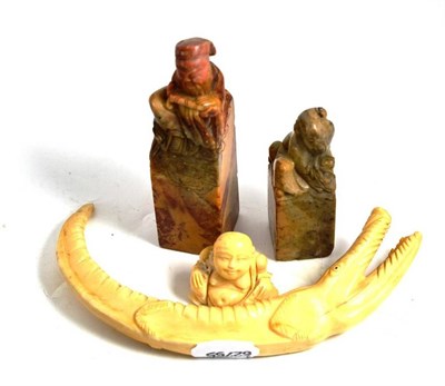 Lot 304 - A carved hippo tusk in the form of a crocodile, a small ivory carving circa 1940 and two...