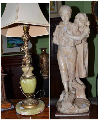 Lot 312 - A carved alabaster figure group of a boy and girl (repairs) and a green onyx table lamp and shade