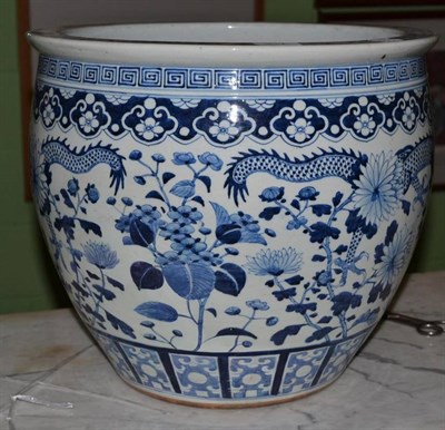 Lot 317 - A 19th century Chinese blue and white porcelain jardiniere, decorated with two dragons amongst...