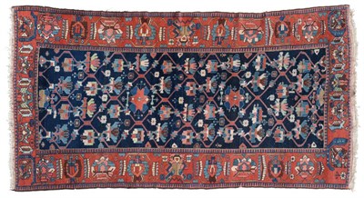 Lot 798 - Good Bakhtiari Rug West Iran, circa 1930 The deep indigo lattice field of flowering plants enclosed