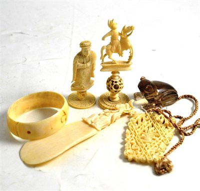 Lot 357 - A collection of carved ivory, circa 1900-1920, including a Chinese pendant, two chess pieces etc