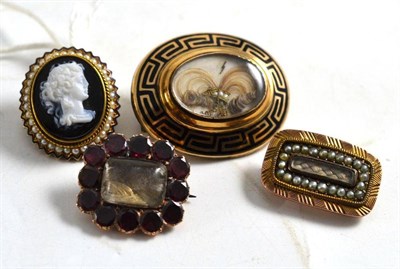 Lot 358 - Three mourning brooches and an agate cameo brooch in a seed pearl and enamel frame (4)