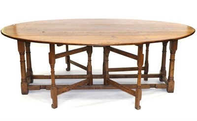 Lot 834 - A 17th Century Style Oak Eight-to-Ten Seater Wake Table, with two rounded drop leaves to form...