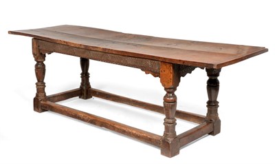 Lot 835 - A 17th Century Joined Oak Refectory Dining Table, the plank top with cleated ends, raised on turned