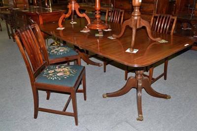 Lot 417 - A Regency style mahogany twin pillar dining table and four Edwardian chairs with drop-in seats