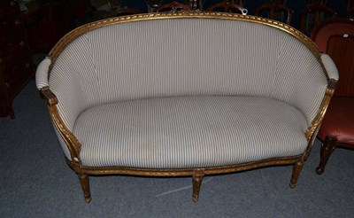 Lot 451 - Late 19th century French gilt canape re-upholstered in blue and white ticking