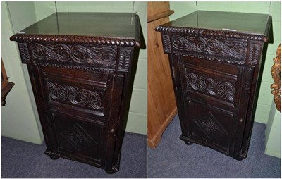 Lot 484 - Pair of carved oak cupboards