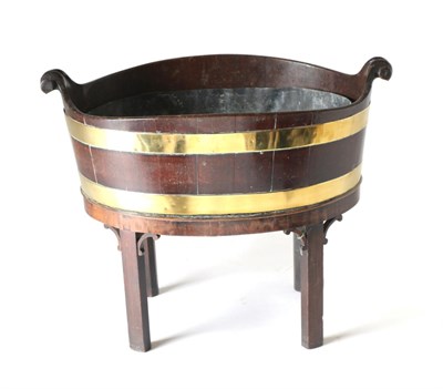 Lot 866 - A George III Mahogany and Brass Bound Wine Cooler, of oval staved construction, with removable lead