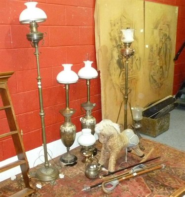 Lot 521 - Brass coal box, two brass spark guards, three oil lamps, table lamp, four standard lamps, two...