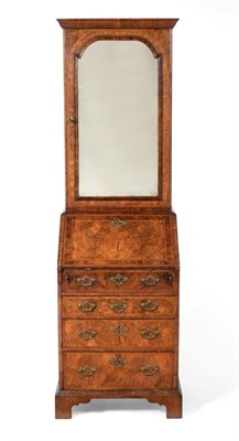 Lot 897 - A Figured Walnut, Crossbanded and Featherbanded Bureau, in George I style, the bold cornice above a