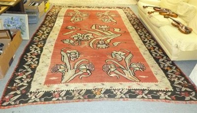 Lot 555 - Karabagh Kilim, South Caucasus, the raspberry field with semi naturalistic plants enclosed by...