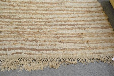 Lot 613 - An unusual Botswana carpet, Southern Africa, the field comprised of bands of natural camel and...