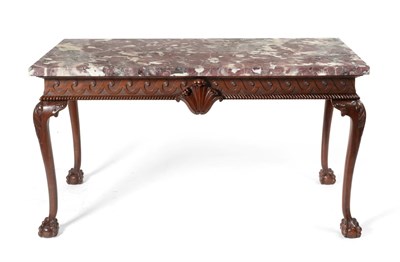 Lot 923 - A Carved Mahogany Serving Table, in George II style, with a fleur de peche marble rectangular...