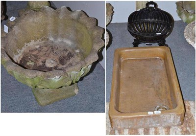 Lot 620 - A pair of composition garden urns, a lamp, trough and dog grate