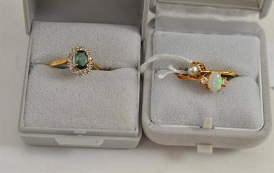 Lot 14 - An 18ct gold opal and diamond three stone ring and two other stone set rings (3)